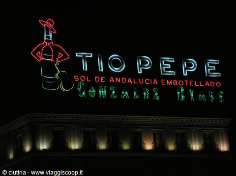 Tio Pepe Gonzalez Byass neon sign glowing at night above the building windows