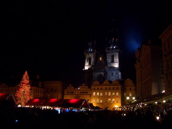Týn Church lit up at night over Prague's Christmas market