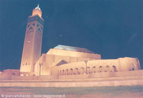 Hassan II Mosque lit at night in Casablanca, minaret and arches