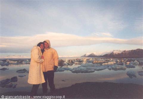 Couple embracing among icebergs at Jökulsárlón lagoon, cold light