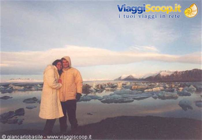Couple embracing among icebergs at Jökulsárlón lagoon, cold light