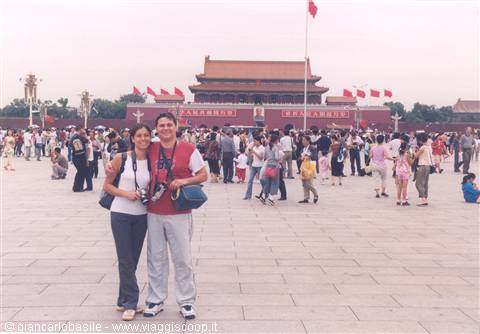 Tourist couple with cameras in front of Tiananmen Gate