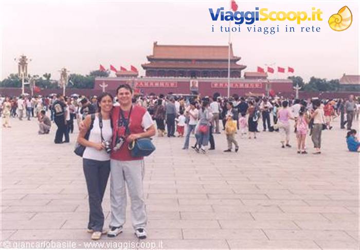 Tourist couple with cameras in front of Tiananmen Gate