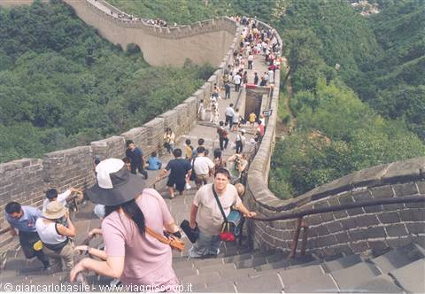 Tourists descend the steep stone steps of the Great Wall