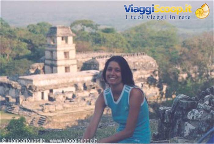 Smiling woman in front of the Mayan temple of Palenque surrounded by jungle