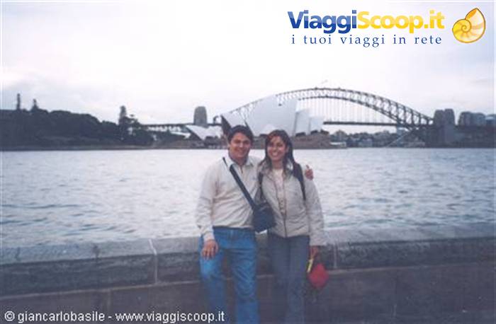Couple posing on the waterfront in front of Sydney Opera House and Harbour Bridge