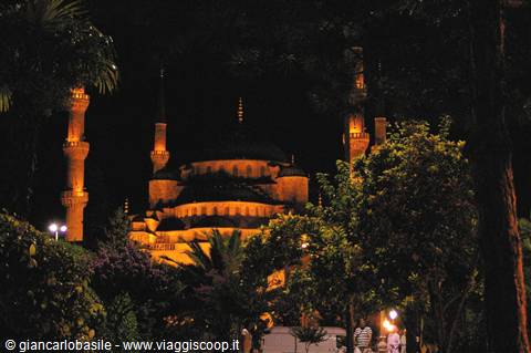 Night in Istanbul: the Blue Mosque lit among minarets and dark trees