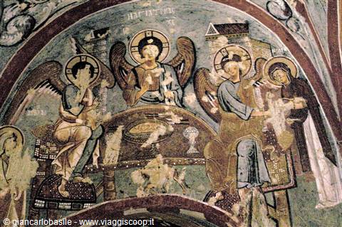 Medieval fresco depicting three winged angels seated at the Eucharistic table