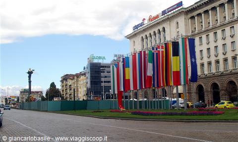 Flags of many nations waving in front of the large government building in Sofia