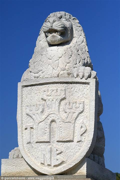 Stone lion statue holding the three-towers coat of arms, San Marino