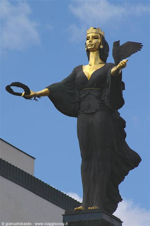Saint Sofia statue in Sofia, dark bronze with gilded face, raven perched on arm