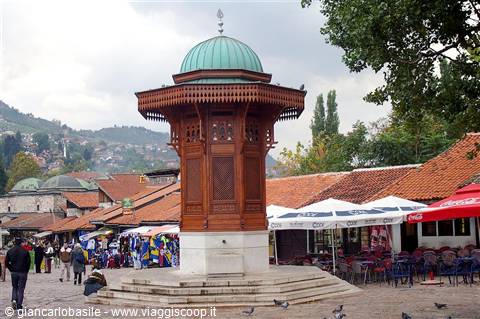 Wooden Sebilj fountain with green dome in Sarajevo's Baščaršija square
