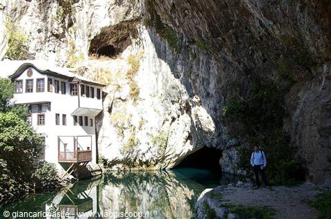 Blagaj Tekke, white dervish monastery at the Buna spring, man standing nearby