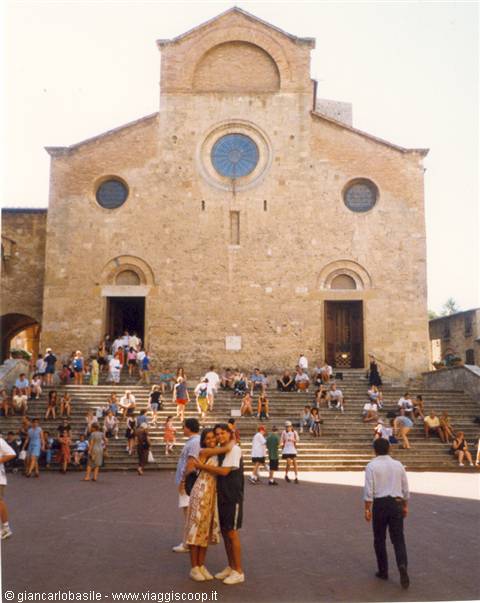 Tourists on the steps of the Romanesque Duomo facade, San Gimignano