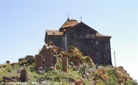Stone church of Sevanavank with cross-stones on the hill