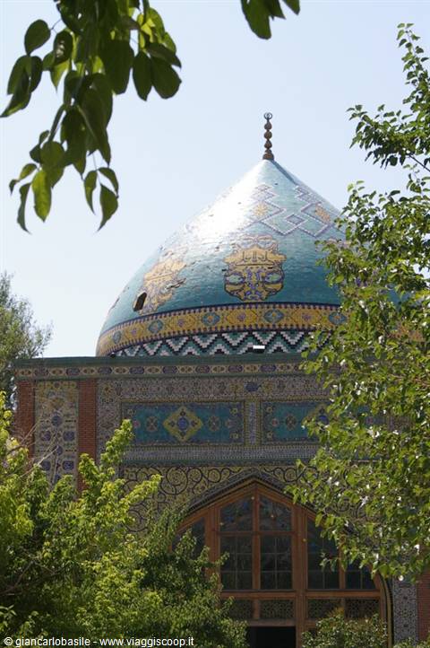 Blue-tiled dome of the Blue Mosque in Yerevan framed by trees