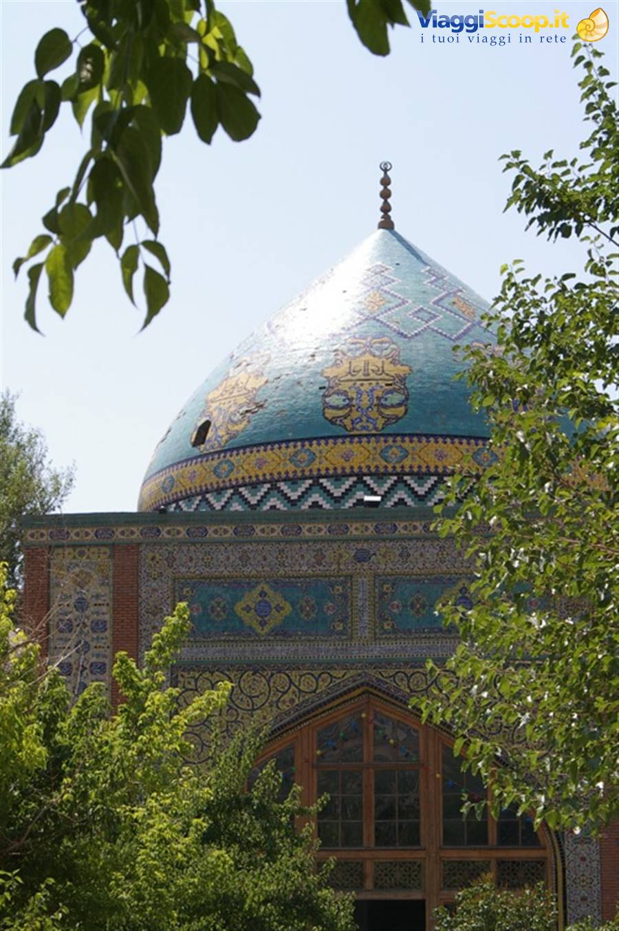 Blue-tiled dome of the Blue Mosque in Yerevan framed by trees