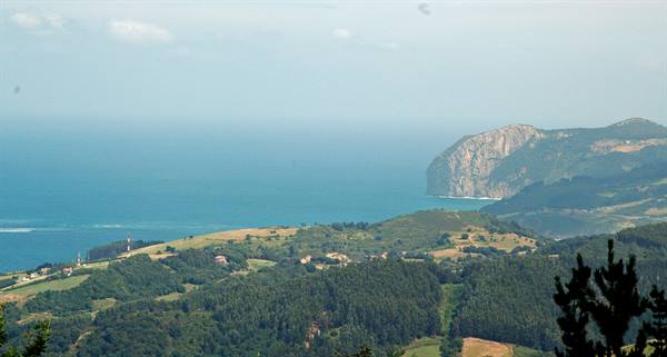 Rocky headlands over the Cantabrian sea above green hills, Basque Country