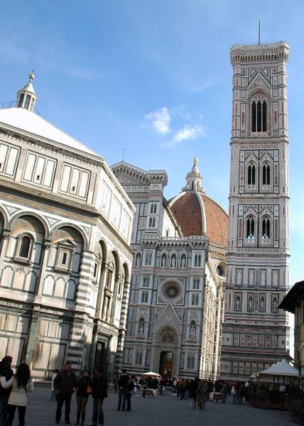 Tourists in Florence's Duomo square, with the Baptistery, Brunelleschi's dome and Giotto's bell tower