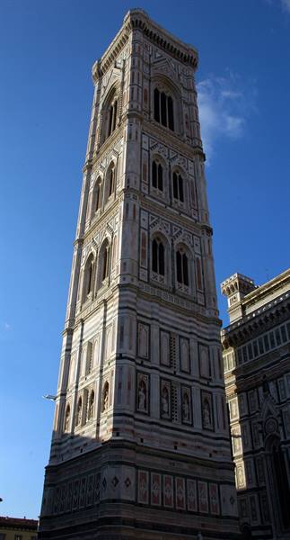 Giotto's Bell Tower in Florence, white and green marble against a blue sky