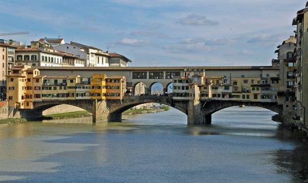 Ponte Vecchio in Florence: colorful shops atop three stone arches over the Arno