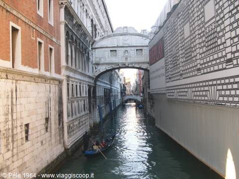 Bridge of Sighs in Venice, a gondola crossing the enclosed canal