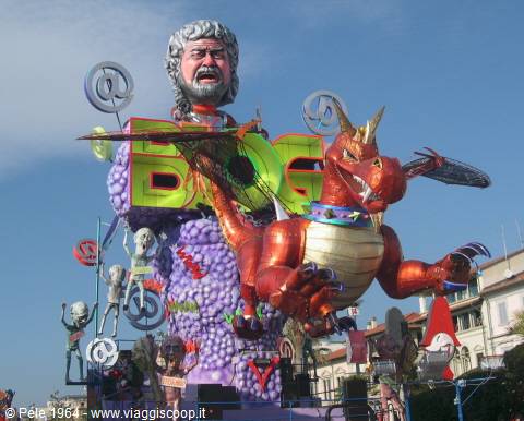 Carnival float in Viareggio, red papier-mâché dragon and giant figure