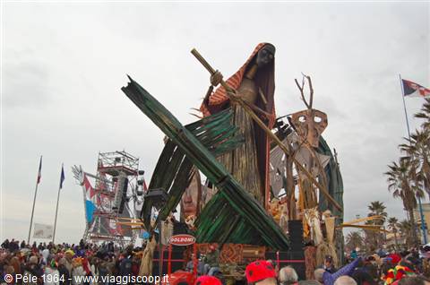 Viareggio Carnival float with giant papier-mâché figure above the crowd