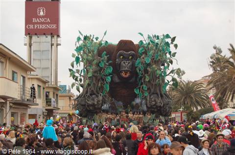Giant gorilla carnival float at Viareggio parade, dense crowd below